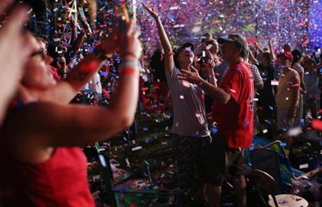 BOSTON, MA - 07/04/2018 People celebrate in the confetti during the Boston Pops Fireworks Spectacular. Despite the heat; 