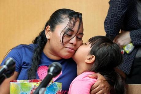 Boston, MA - July 05, 2018: Angelica Rebeca Gonzalez-Garcia comforts her 8-year-old daughter, Sandy, during a press conference, after being reunited at Logan International Airport in Boston, MA on July 05, 2018. The little girl was taken from her at the US-Mexican border after she and her mother fled Guatemala fearing for their lives and seeking asylum in the US. It has been nearly two months since Gonzalez-Garcia has seen her child. She sued the federal government last week demanding the immediate release of the little girl. (Four nearly identical federal lawsuits, all demanding the immediate release of their children who were forcibly taken from them at the US-Mexican border as a result of the Trump administration?s zero-tolerance policy for people who enter the country illegally. All four mothers were told the same thing: A recent rule change by the federal government now requires everyone in the house where they will reside be fingerprinted for criminal and immigration background checks, a process that could take weeks. The children have been placed in a system designed for those who actually enter the country without parents and are captive to bureaucratic malaise -- or cruelty depending on who's asked.) (Craig F. Walker/Globe Staff) section: metro reporter:
