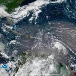 In this geocolor image GOES-16 satellite image taken Sunday, July 8, 2018, at 15:00 UTC, shows Tropical Storm Beryl, center right, moving across the Lesser Antilles in the eastern Caribbean Sea, and Tropical Storm Chris, top left, off the U.S. East Coast. (NOAA via AP)