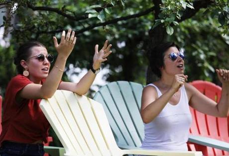 CAMBRIDGE, MA - 07/10/2018 Sarah Terriere, left, and Lea Sasbortes, both visiting Boston from France, react to the Belgium and France World Cup game. A crowd of a few dozen people gathered to watch France play Belgium on a Jumbotron at University Park Commons. Erin Clark for the Boston Globe
