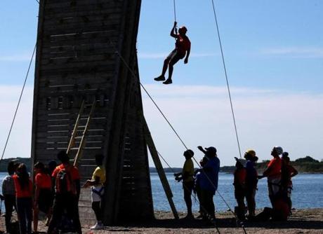 BOSTON, MA - 7/12/2018: At Camp Harbor View....... hanging off wall from rope after a climb is camper Adrian Torres (David L Ryan/Globe Staff ) SECTION: METRO TOPIC 13camppic
