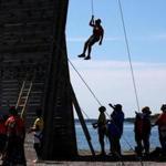 BOSTON, MA - 7/12/2018: At Camp Harbor View....... hanging off wall from rope after a climb is camper Adrian Torres (David L Ryan/Globe Staff ) SECTION: METRO TOPIC 13camppic