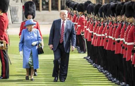WINDSOR, ENGLAND - JULY 13: U.S. President Donald Trump and Britain's Queen Elizabeth II inspect a Guard of Honour, formed of the Coldstream Guards at Windsor Castle on July 13, 2018 in Windsor, England. Her Majesty welcomed the President and Mrs Trump at the dais in the Quadrangle of the Castle. A Guard of Honour, formed of the Coldstream Guards, gave a Royal Salute and the US National Anthem was played. The Queen and the President inspected the Guard of Honour before watching the military march past. The President and First Lady then joined Her Majesty for tea at the Castle. (Photo by Richard Pohle - WPA Pool/Getty Images)
