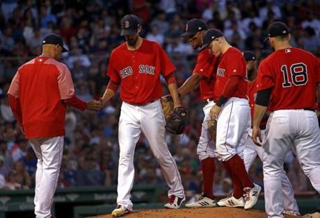 Boston, MA - 7/13/2018 - (3rd inning) Boston Red Sox starting pitcher Rick Porcello hands the ball off to Boston Red Sox manager Alex Cora after getting rocked for 5 runs in the third inning. The Boston Red Sox host the Toronto Blue Jays at Fenway Park. - (Barry Chin/Globe Staff), Section: Sports, Reporter: Peter Abraham, Topic: 14Red Sox-Blue Jays, LOID: 8.4.2478772210.
