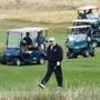 US President Donald Trump, center, walked as he plays a round of golf on the Ailsa course at Trump Turnberry, his luxury golf resort, in Turnberry, southwest of Glasgow, Scotland on Saturday.