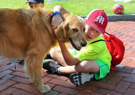 Colin Carlson, 8, enjoyed a hug with Dawn, the therapy dog that visited the kids at Camp Kangaroo.
