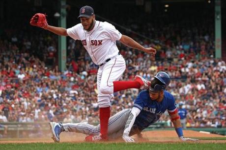 Boston, MA - 7/14/2018 - (6th inning) Boston Red Sox starting pitcher Eduardo Rodriguez had to leave the game during the sixth inning after this collision with Toronto Blue Jays second baseman Lourdes Gurriel Jr. while covering the base. The Boston Red Sox host the Toronto Blue Jays at Fenway Park. - (Barry Chin/Globe Staff), Section: Sports, Reporter: Peter Abraham, Topic: 15Red Sox-Blue Jays, LOID: 8.4.2501798385.
