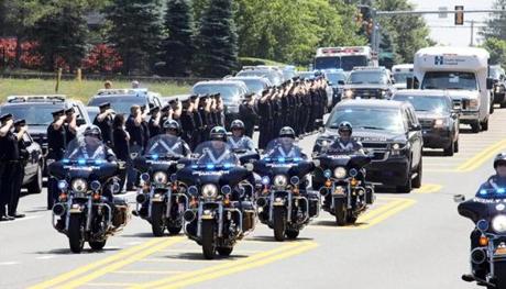 Police in Weymouth saluted along Main Street as the body of officer Michael Chesna was brought to the medical examiner?s office in Boston.  
