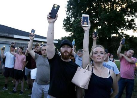Weymouth, MA--7/16/2018-- People hold up cellphones with a candle on them at a candlelight vigil for slain Weymouth police officer Michael Chesna. (Jessica Rinaldi/Globe Staff) Topic: 17weymouthpic Reporter: 
