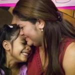 FILE - In this July 13, 2018, file photo, Allison, 6, and her mother Cindy Madrid share a moment during a news conference in Houston, where the mother and daughter spoke about the month and one day they were separated under the President Donald Trump administration immigration policy. The Trump administration is due back in court Monday, July 16, 2018, to discuss a plan reunify more than 2,500 children who were separated at the border from their parents. (Marie D. De Jes's/Houston Chronicle via AP, File)