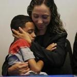 Allston, MA--7/16/2018-- An Immigrant mother who has asked to be identified by the initials W.R. cradles her 9 year-old son, A.R. during a press conference at the Brazilian Worker Center. (Jessica Rinaldi/Globe Staff) Topic: 17reunionpic Reporter: 