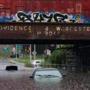 Two flooded out vehicles sit under the railroad bridge on Cambridge Street in Worcester, Massachusetts on July 17, 2018. Heavy rain caused flash flooding in many parts of the region. Photo by Matthew Healey