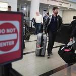 Travelers arriving at the international terminal of O'Hare International Airport in Chicago on April 25, the day the Supreme Court began hearing arguments to determine if President Trump's limited travel ban overstepped his power because it singles out several mostly Muslim nations.