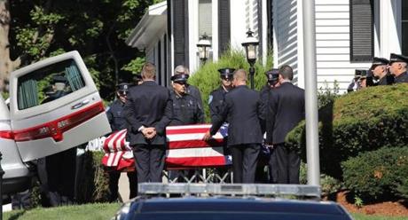 The body of Weymouth Police Sgt. Michael Chesna is escorted from the McDonald Keohane Funeral Home, in Weymouth, to St. Mary of the Sacred Heart Church in Hanover.
