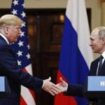 President Donald Trump shakes hands with Russian President Vladimir Putin at the end of their press conference in Helsinki, Finland on Monday.