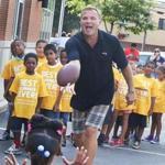 9-2-2015 Newton, Mass. Children from West Roxbury YMCA were at the Xfinity Store in Newton watching a demonstration for Xfinity Sports App,, kids playig around with former New England Patriots back up Scott Zolak from 98.5 The Sports Hub. Glob photo by Bill Brett