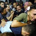 Palestinians reacted after their relative was shot dead by Israeli forces during protests east of Gaza City on Friday.