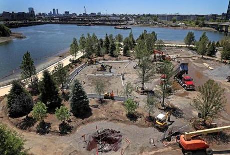 The grounds of the Encore Boston Harbor casino and hotel are a garden in the making. The work to build a riverwalk on the former industrial site is well underway.
