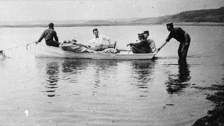 In this photo provided by the Orleans Historical Society, injured crewman John Bogovich is transported to the beach after a German World War I submarine attack on Orleans, Mass., on July 21, 1918. Orleans was the only town on U.S. soil to receive enemy gunfire during World War I. (Courtesy of Orleans Historical Society via AP)
