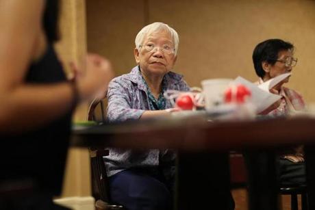 Boston, MA., 07\18\18, Yuet Fong Hom, cq, listens to the presentaton of the end of life class. At the Kenmore Abbey Apartments, Chinese residents and staff gather for a 
