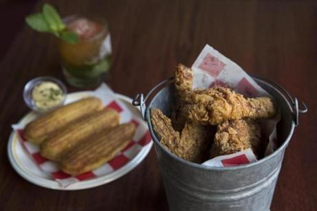 Fried chicken served in a bucket with cornbread, butter, and a mint julep at the Frogmore. 

