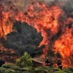Firefighters tried to extinguish flames during a wildfire at the village of Kineta, near Athens on Tuesday.