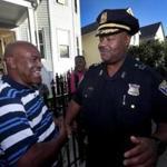 Newly appointed Boston Police Commissioner William Gross talked with Zeca Afonso on Clarkson Street in Dorchester on Tuesday during the Bowdoin-Geneva Peace Walk.