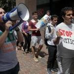 Matt Frentz, the organizing manager at Hildreth Institute, shouted slogans Wednesdayat a protest over rising tuition at the downtown Beacon Street offices of the UMass system.