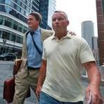 Boston, MA: 7-25-18: Retired Massachusetts State Trooper Daren DeJong (right) is pictured as he leaves the Moakley Federal Courthouse after being arraigned inside for embezzlement. His lawyer Brad Bailey is with him. (Jim Davis/Globe Staff) 
