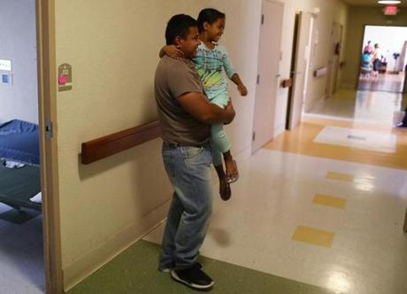 A man, identified only as Luis, spent time with his daughter, Selena, 6, as they relaxed together in an Annunciation House facility after they were reunited on Thursday in El Paso, Texas.
