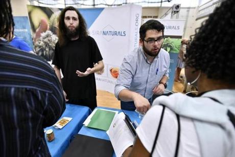 BOSTON, 7/25/2018 - From left, Processing Technician Aaron Wang and Director of Marketing Nic DiBella of Somervile and Cambridge Based marijuana product producer Siri Naturals speak with prospective employees at the cannabis industry job fair and expungement clinic at the Reggie Lewis Track and Athletic Center in Roxbury. Josh Reynolds for The Boston Globe (Metro, Desk ) 
