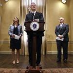 Gov. Charlie Baker, center, is flanked by Lt. Governor Karyn Polito, left, and Secretary of Administration and Finance Michael Heffernan, right, as he addresses reporters after signing the 2019 budget at the Statehouse in Boston, Thursday, July 26, 2018. (AP Photo/Charles Krupa)