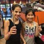 Sophia Cukras (left) and Amanda He enjoying a cold drink at Dunkin' Donuts with a reusable stainless straw.