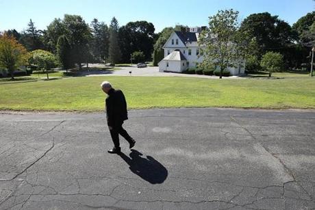 Waltham, MA., 07/20/18, Reverend Robert White walks through the bucolic campus of the Espousal Retreat Center. He is the leader of a small Catholic order, the Stigmatines, who are fighting a proposal by the city to take their land by eminent domain for the construction of a new high school. Suzanne Kreiter/Globe staff

