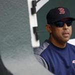 Boston Red Sox manager Alex Cora sits in the dugout before a baseball game against the Baltimore Orioles, Wednesday, June 13, 2018, in Baltimore. (AP Photo/Patrick Semansky)