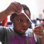 Jaida Thomas, 9, was very attentive during an experiment to extract DNA from a strawberry.