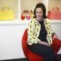This May 13, 2004 photo shows designer Kate Spade posing among handbags and shoes from her collection in New York. (AP Photo/Bebeto Matthews, File)