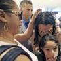 Alejandra Juarez,38, left, says goodbye to her children, Pamela and Estela at the Orlando International Airport on Friday, Aug. 3, 2018 in Orlando, Fla. Juarez, the wife of a former Marine is preparing to self-deport to Mexico in a move that would split up their family. (Red Huber/Orlando Sentinel via AP)