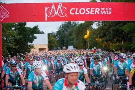 Cyclists make their way through the gate at the start of the 2018 Pan-Mass Challenge in Sturbridge, Massachusetts on August 4, 2018. Thousands of cyclists participate in the yearly ride which raises money for cancer research. Photo by Matthew Healey
