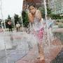 BOSTON - 06/18/2018 Lily Ward, age seven, plays in Rings Fountain on a warm summer day. Lily, of Leominster, visits Boston once a year with her parents. Erin Clark for The Boston Globe 