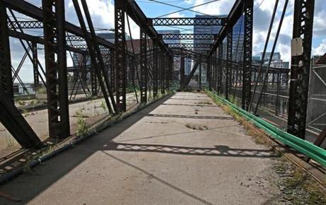 Engineers cited rotting floorboards when they closed the bridge in 2014 (left). A decision on retaining parts of the bridge or replacing it entirely is expected later this year.
