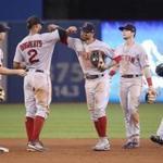 Mookie Betts (center) celebrated the victory with Xander Bogaerts during a game against the Toronto Blue Jays on Tuesdsay.