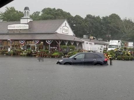 Flooding due to heavy rain in the parking lot of Friends Marketplace in Orleans Thursday. 

