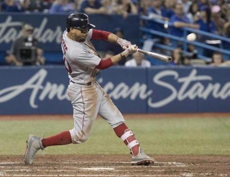 Boston Red Sox's Mookie Betts hits a home run against the Toronto Blue Jays during the ninth inning of a baseball game Thursday, Aug. 9, 2018, in Toronto. (Fred Thornhill/The Canadian Press via AP)
