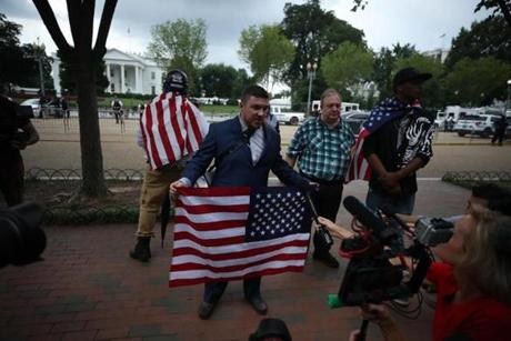 WASHINGTON, DC - AUGUST 11: Jason Kessler (C), who organized the rally, speaks as white supremacists, neo-Nazis, members of the Ku Klux Klan and other hate groups gather for the Unite the Right rally in Lafayette Park across from the White House August 12, 2018 in Washington, DC. Thousands of protesters are expected to demonstrate against the 