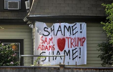 Boston, MA - 08/14/18 - A sign calling out Jim Koch, the co-founder and chairman of the Boston Beer Company, the producers of Samuel Adams beer, for a pro-Trump statement. The sign hangs on a house visible from the parking lot in Jamaica Plain that the brewery uses. (Lane Turner/Globe Staff) Reporter: () Topic: ()
