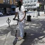 Vatic Kuumba rode an electric scooter in downtown Providence.