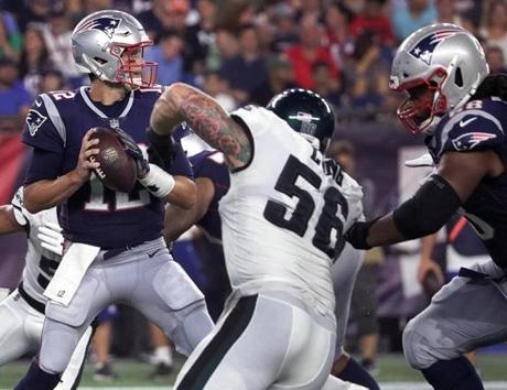 Boston, MA - 8/16/2018 - (2nd quarter) New England Patriots offensive lineman LaAdrian Waddle (68) keeps Philadelphia Eagles defensive end Chris Long (56) away from New England Patriots quarterback Tom Brady (12) standing in the pocket during the second quarter. The New England Patriots host the Philadelphia Eagles in the second pre-season home exhibition game at Gillette Stadium. - (Barry Chin/Globe Staff), Section: Sports, Reporter: James M. McBride, Topic: 17Patriots-Eagles, LOID: 8.4.2854134805.
