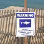 Kenneth Dutra was on duty at Longnook Beach. Warnings are posted about sharks and the possible danger of swimming.