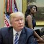 FILE - In this March 12, 2017 file photo, White House Director of communications for the Office of Public Liaison Omarosa Manigault, right, walks past President Donald Trump during a meeting on healthcare in the Roosevelt Room of the White House in Washington. Manigault Newman, who was fired in December, released a new book 